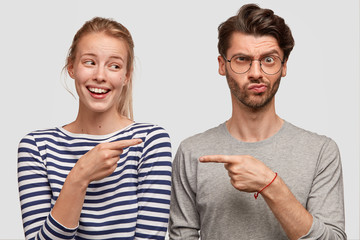 Horizontal shot of two female and male best friends express different emotions, pose together...