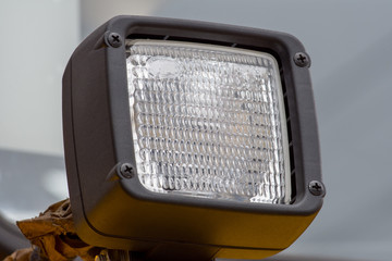 Signal headlamp protected by a grating from a heavy truck for industrial purposes
