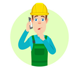 Builder talking on mobile phone and standing with his finger to his lips