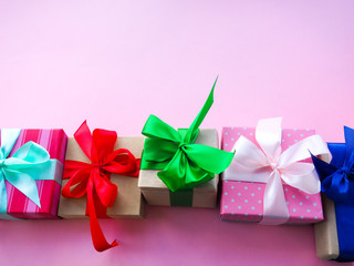 funny gift boxes on pink background, the concept of gift for the holiday