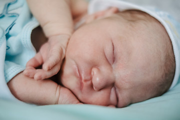 Newborn baby sleeping at home. Close up