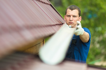 master repairs the drain on the roof, close-up