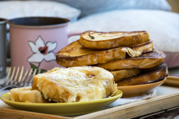 Delicious breakfast in bed with toast and a big cup of coffee