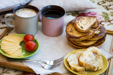 Delicious breakfast in bed with toast and a big cup of coffee