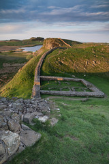 Beautiful landscape image of Hadrian's Wall in Northumberland at sunset with fantastic late Spring light