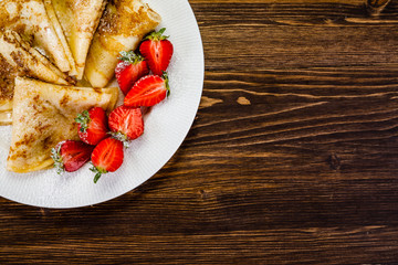 Crepes with cream and strawberries