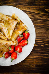 Crepes with cream and strawberries