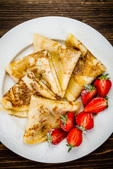 Crepes with cream and strawberries