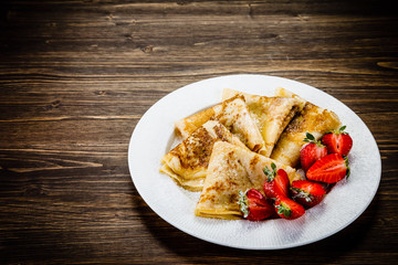 Crepes with cream and strawberries