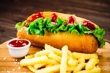 Hot dog and french fries on cutting board