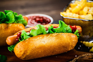 Hot dogs and french fries on cutting board