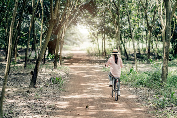 asian woman with vntage bicycle in forest travel ideas concept