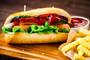 Hot dog and french fries on cutting board