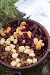 Dried fruits in a clay plate.Mix of nuts and berries in a plate.