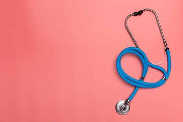 Fototapeta premium Top view of stethoscope on pink background. Flat lay and copy space. Medical Concept.