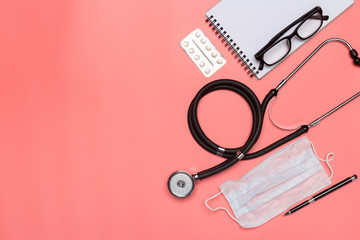 Medical equipment on a pink pastel background.