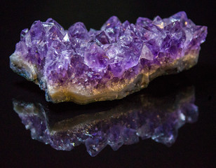 Natural untreated druse of amethyst on a black background