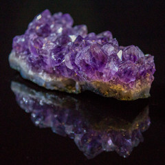 Natural untreated druse of amethyst on a black background