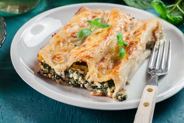 Portion of cannelloni stuffed with spinach