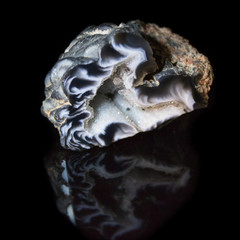 Natural geode polished agate on a black background