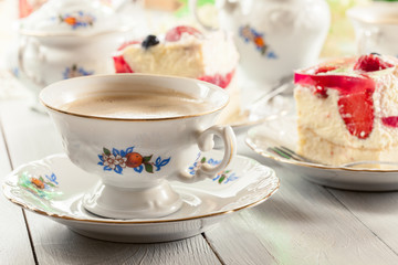 Cup of coffee served with cheesecake