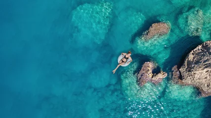 Foto op Canvas Luchtfoto op het meisje op het zeeoppervlak. Mooie compositie in de zomer © biletskiyevgeniy.com