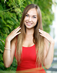 portrait of beautiful girl outdoors in red dress