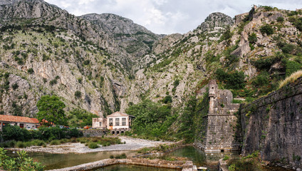 Fototapeta na wymiar Panoramic view to mountains and old historical city wall in the ancient town of Kotor, Montenegro