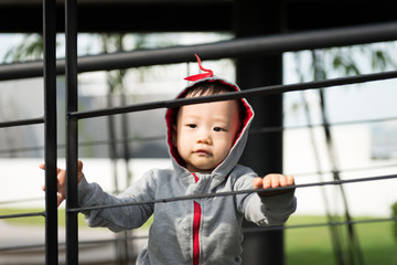 Portrait of little Asian baby boy at outdoor park