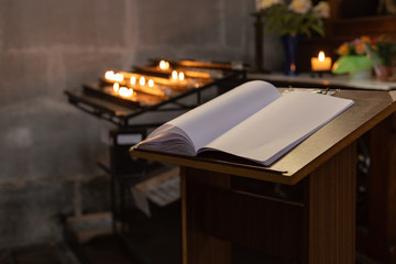 votive altar in church with emtpy guestbook