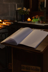votive altar in church with emtpy guestbook