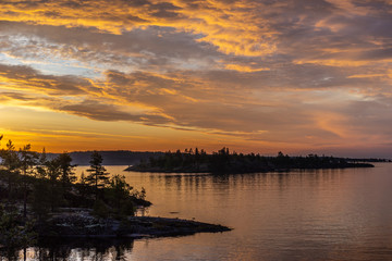 Obraz premium Clouds over the water. Sunrise. Gold clouds. Karelia Russia. Nature of Karelia. Ladoga lake.