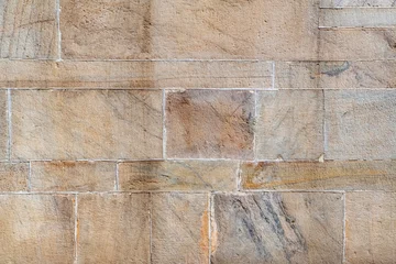 Foto op Plexiglas Steen Stenen muur textuur achtergrond. Materiële constructie en architectonisch detail.