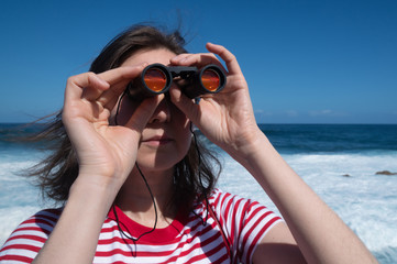 Girl looking through binoculars