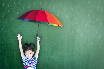 Family plan for child education and insurance protection concept with student holding umbrella on...