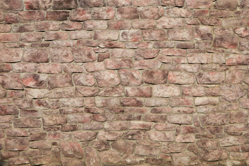 Wall of red stone. Background / texture.