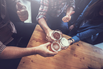 businessteam relaxing and talking in nightclub ; businessman drinking beverage in counter at nightclub