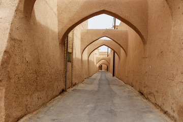 Narrow street with arches of old town in Yazd. Iran
