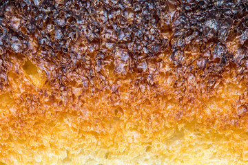 The detail of roasted toast. Part of toast close up. Abstract surface of pastries, macro view.