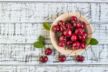 Fresh cherry on plate on wooden blue background. fresh ripe cherries. sweet cherries.