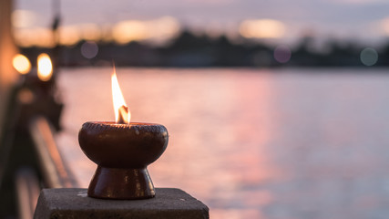 Spirituality and tranquility abstract concept with candle light illumination and golden sunset sky