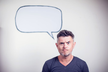 Portrait of a young man with a empty speech bubble over his head