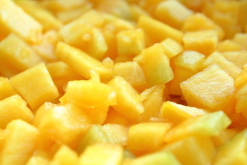 Pumpkin cut into small pieces. Close-up. Background. Texture.