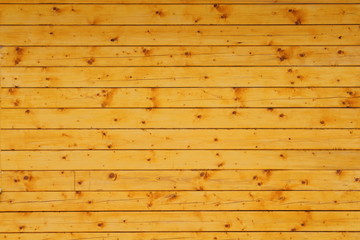New log house of pine. Close-up. Background. Texture. Horizontal view.