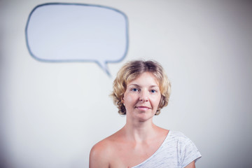Blond woman thinking and looking up to blank bubble speech