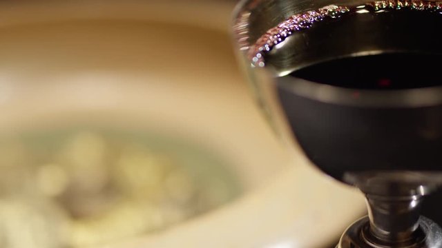 Bitcoin close up wine rack focus to coins in collection plate 