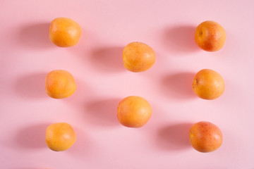 Fototapeta na wymiar Top view flat lay apricots on pink background.