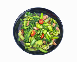 stir fried spicy asian vegetables with black plate on white background