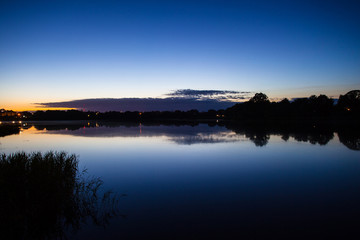 forest by the lake at dusk, long exposure