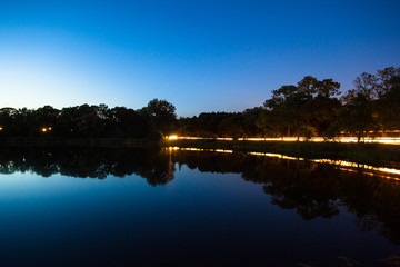 forest by the lake at dusk, long exposure